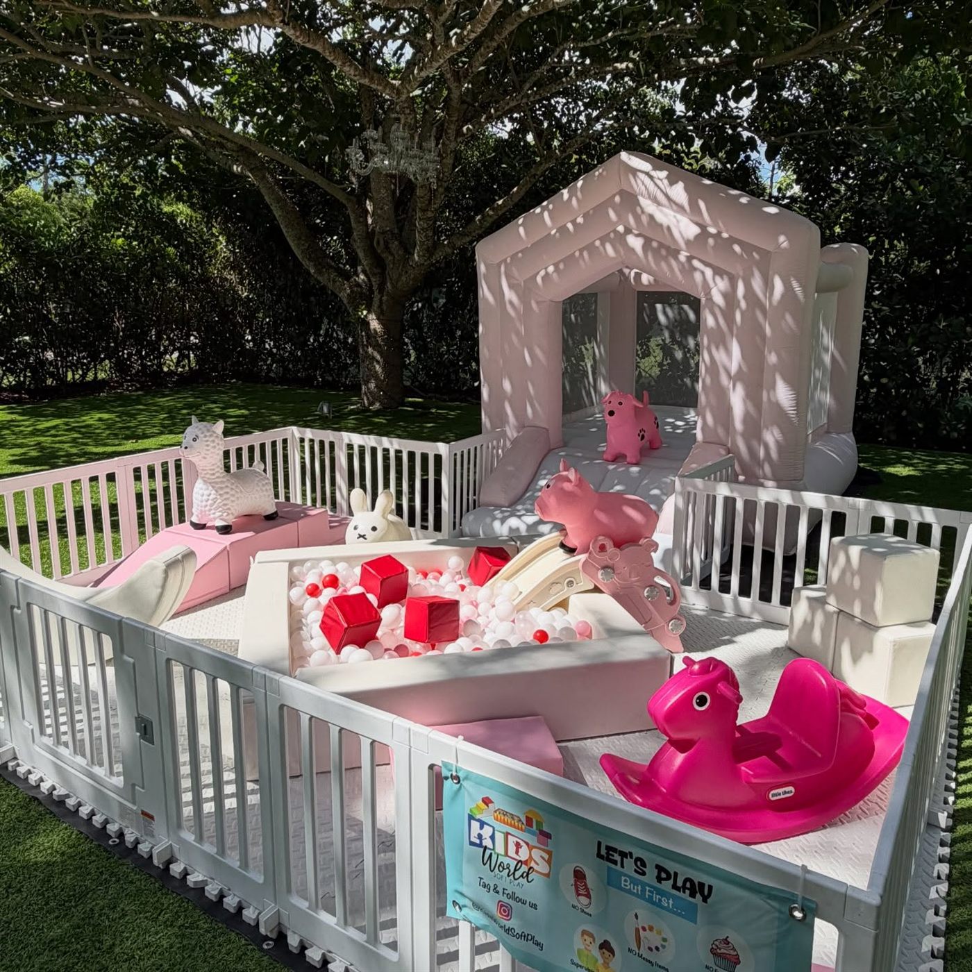 Pink and white Kids World soft play with ball pit and bounce house