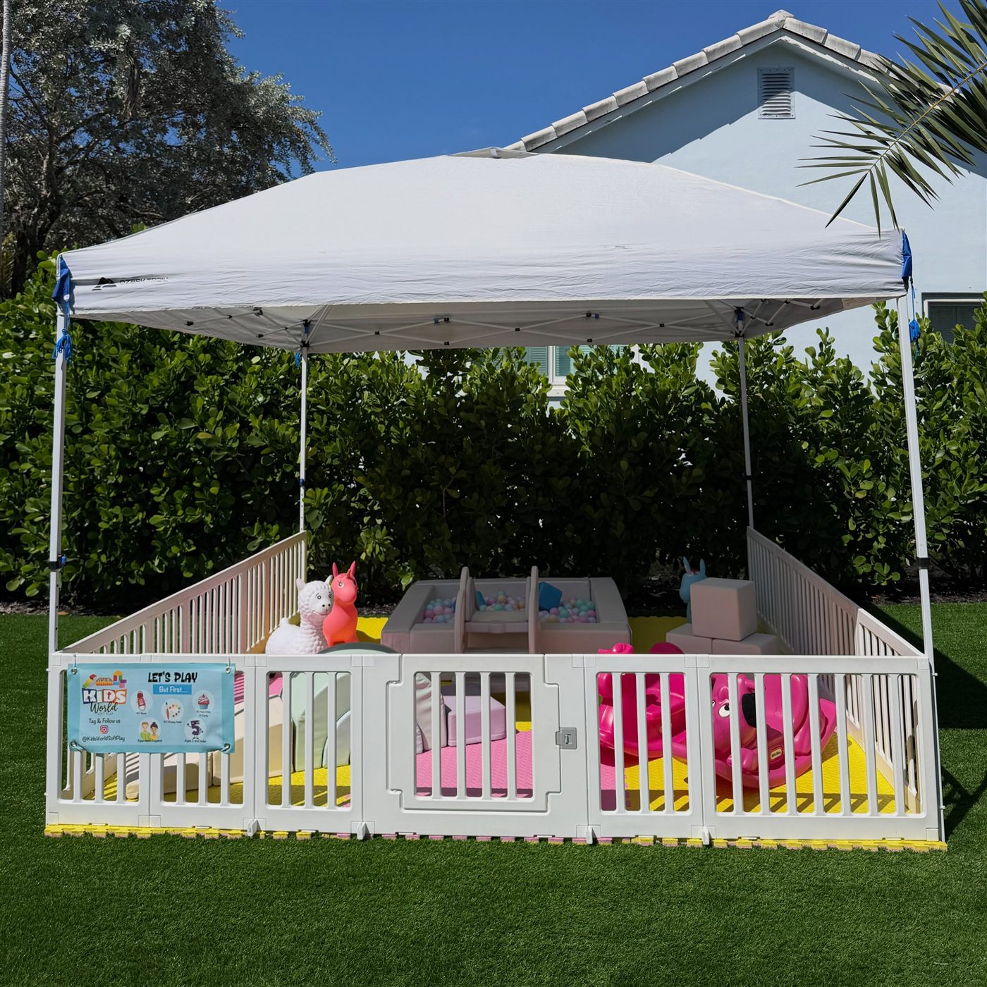 Pastel soft-play setup beneath a party canopy