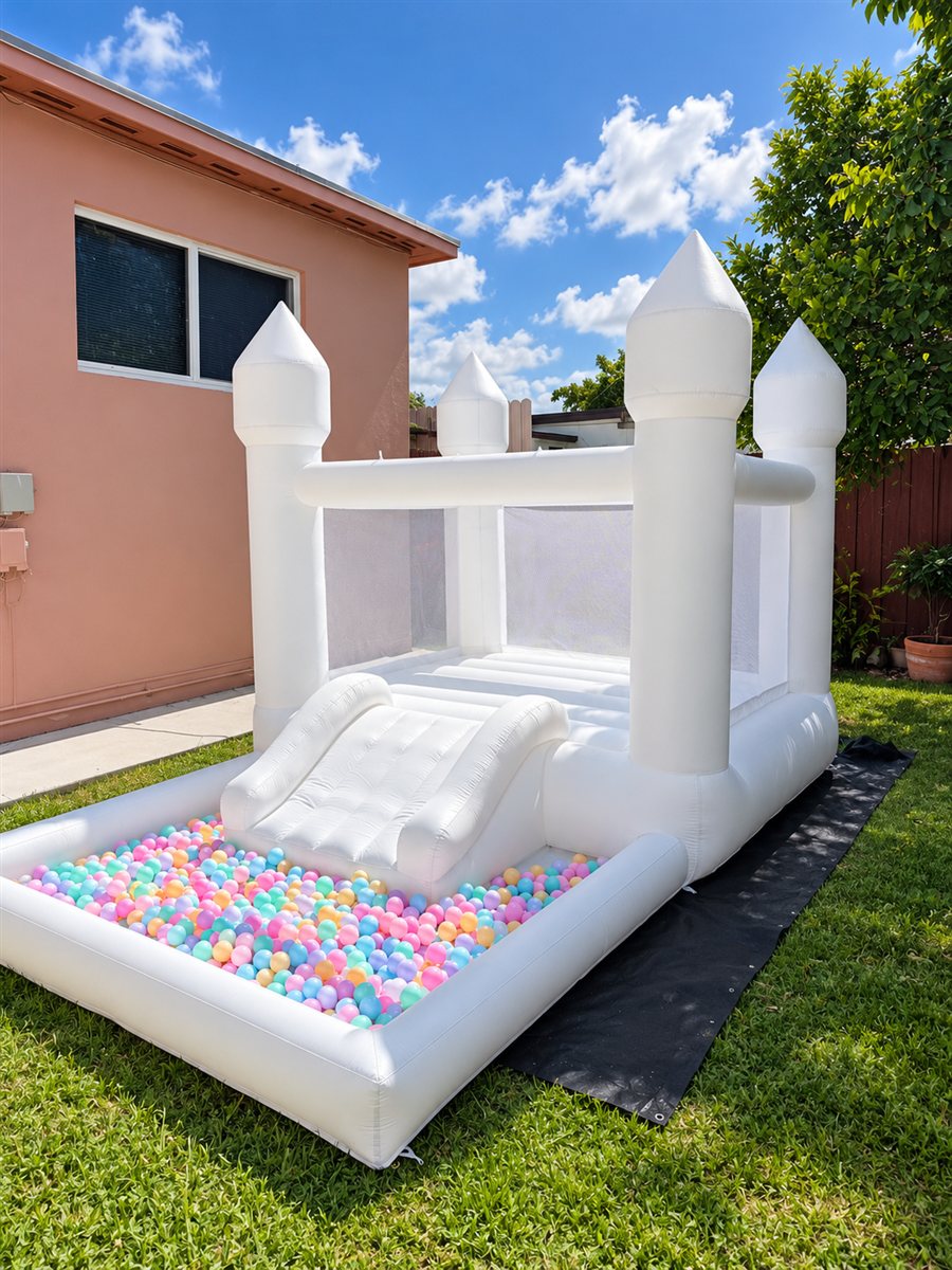 White toddler bounce house with slide and colorful ball pit